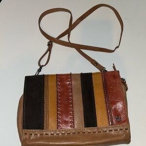 The sak. 100% leather body, soft, brown, leather adjustable cross body strap.